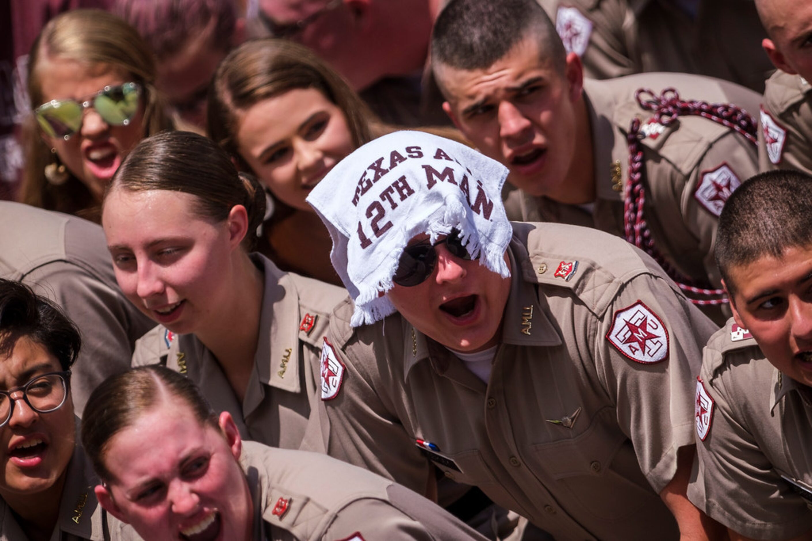 Members of the Texas A&M Corps of Cadets try to beat the heat during the first quarter of an...