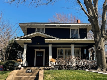 Prairie home with green yard against blue sky