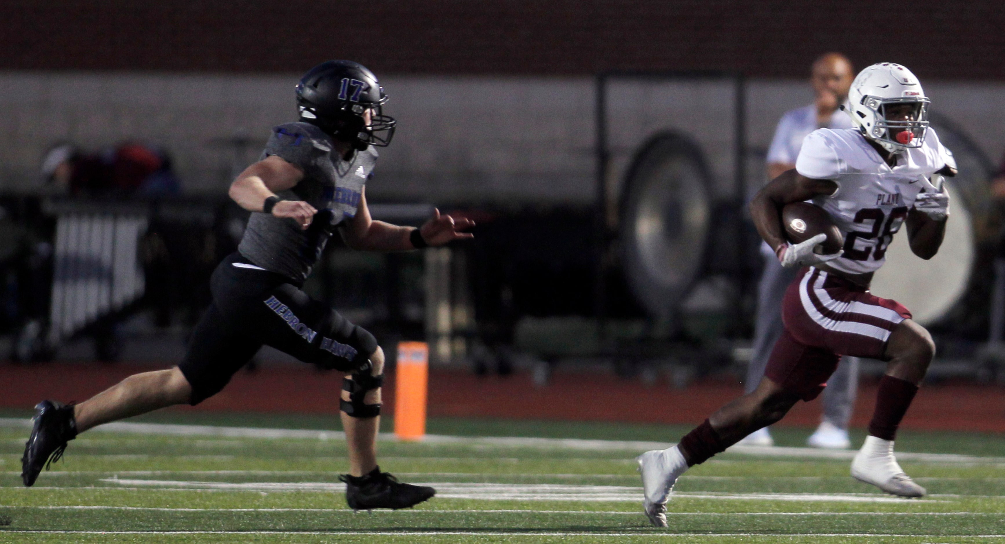 Plano running back Kameron Jones (26), right, tacks on yardage after a first half reception...