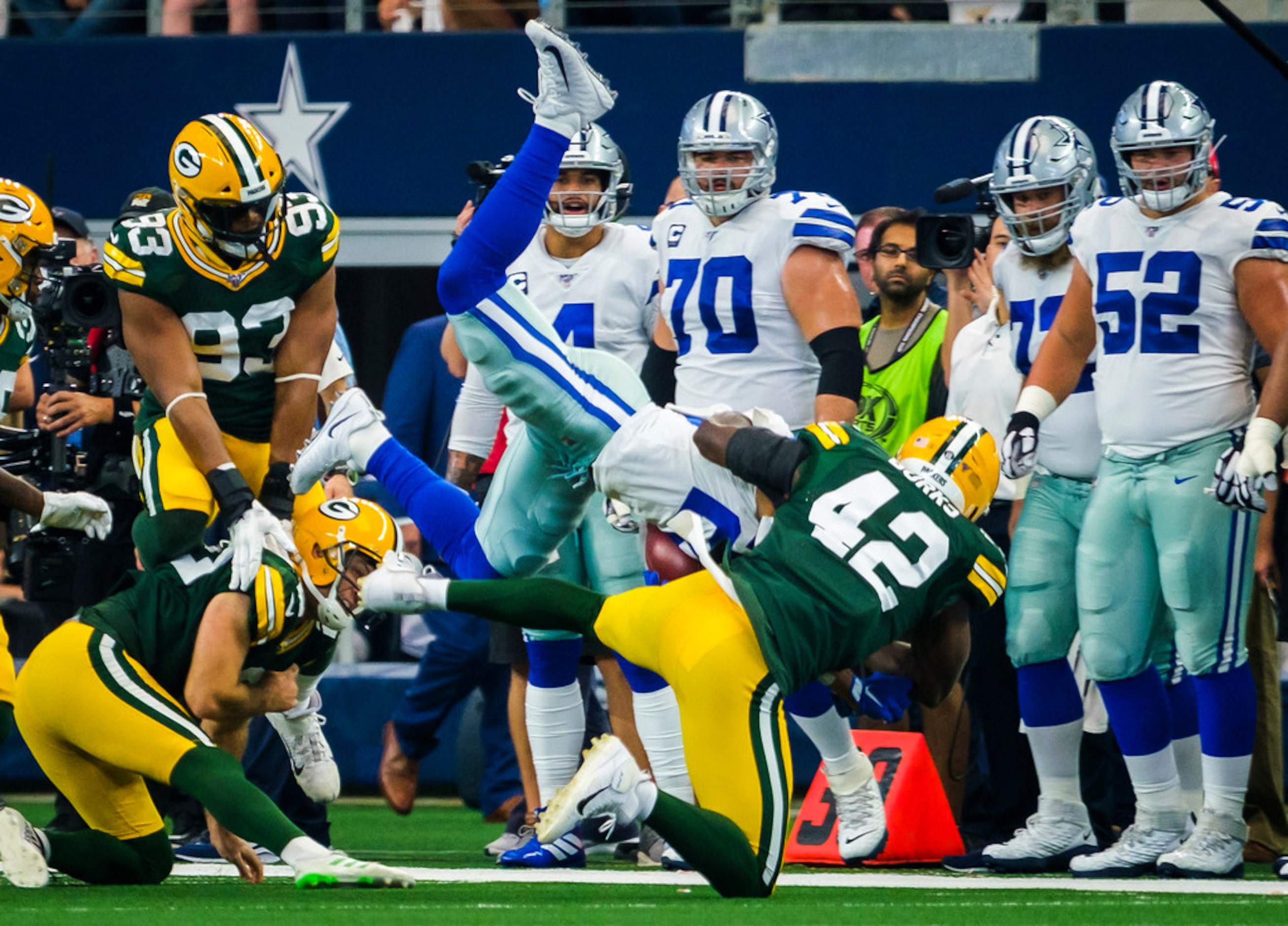 Dallas Cowboys running back Tony Pollard (20) is upended on a kick return during the first...