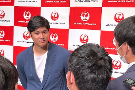 Los Angeles Angels' Shohei Ohtani speaks to reporters after he returned home, at the Haneda...