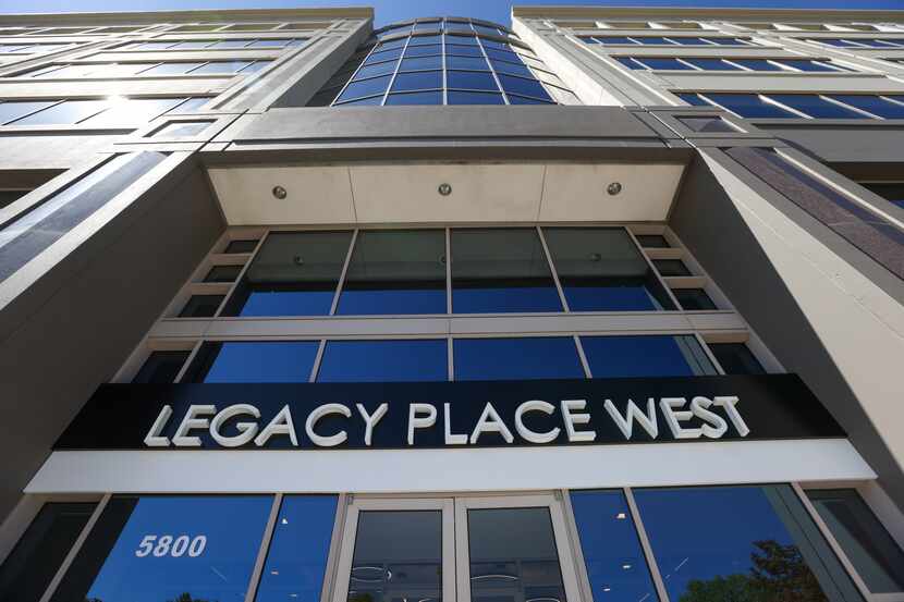 A sign marks the entrance to Legacy Place West. The building houses the Plano headquarters...