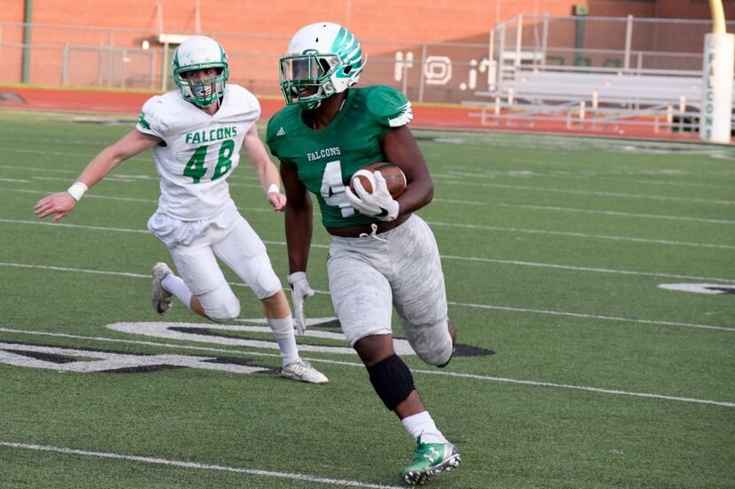 Lake Dallas Falcon Charles Williams (4) makes a run for first down during the Falcon's...
