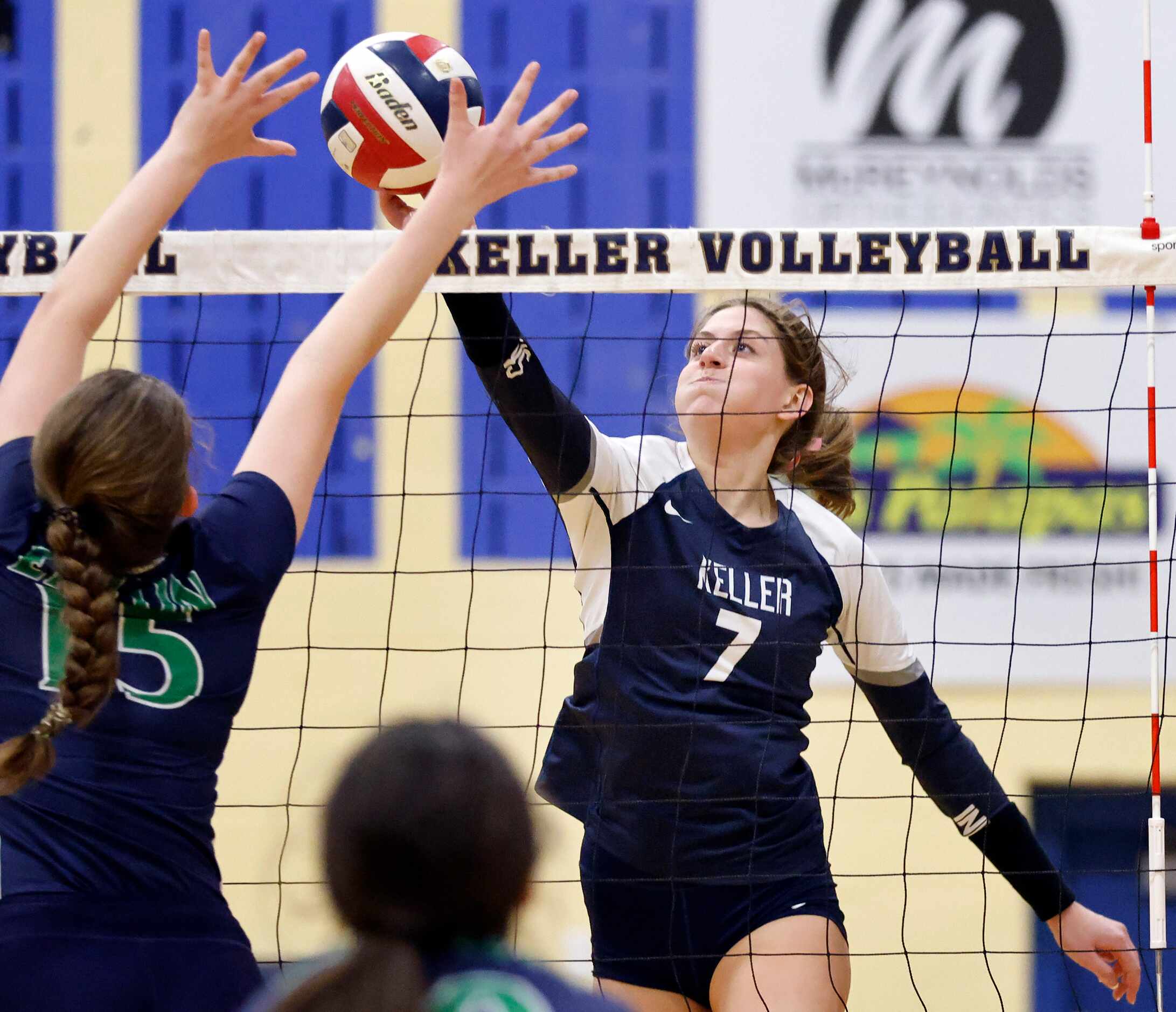Keller High’s Reagan Sharp (7) attempts to spike the ball past Eaton High’s Angela Boaz (15)...