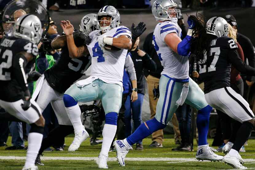 Dallas Cowboys quarterback Dak Prescott (4) is tackled by Oakland Raiders outside linebacker...