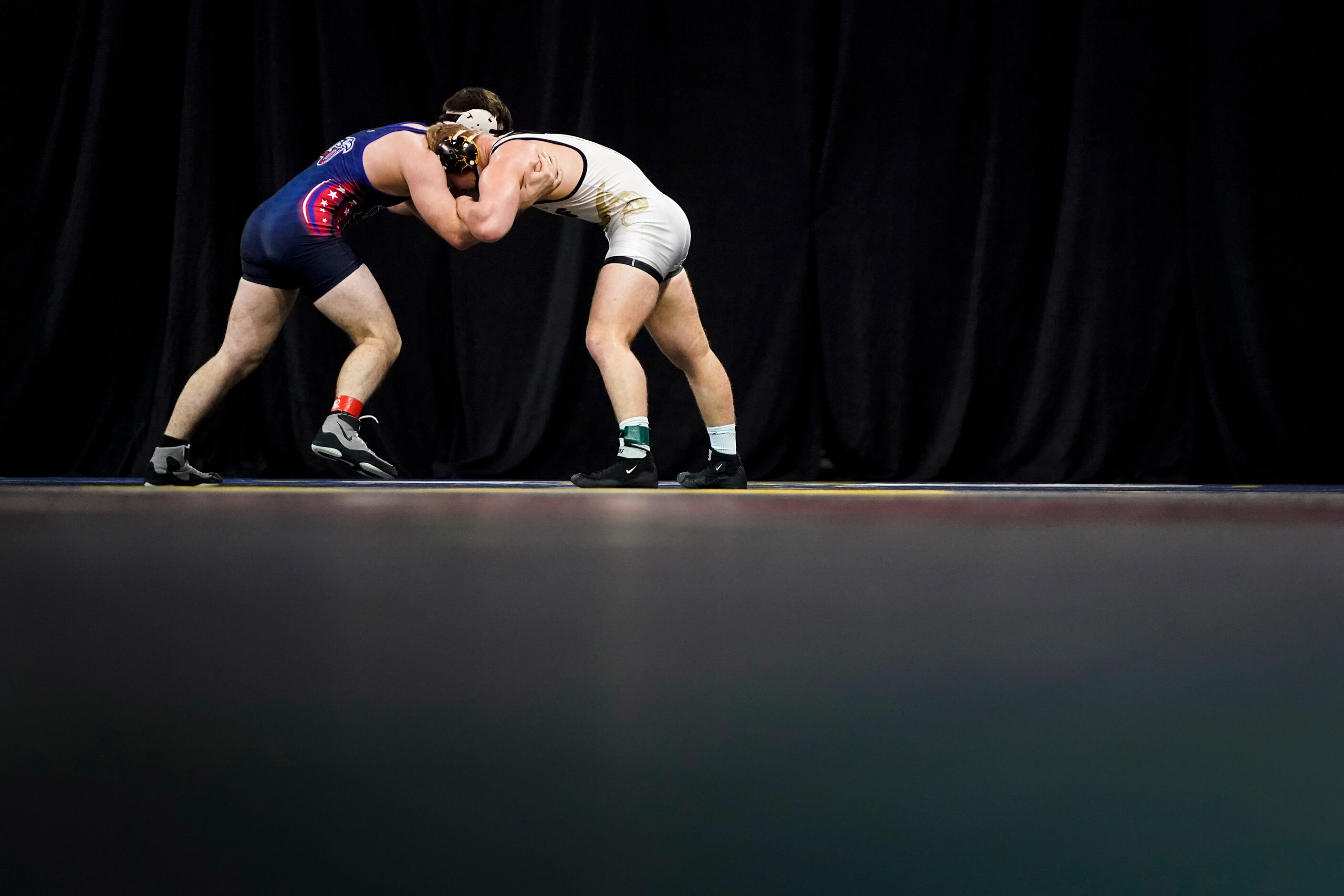 Jarrod Smiley of the University Of Central Florida (facing) wrestles Ethan Martin of Liberty...