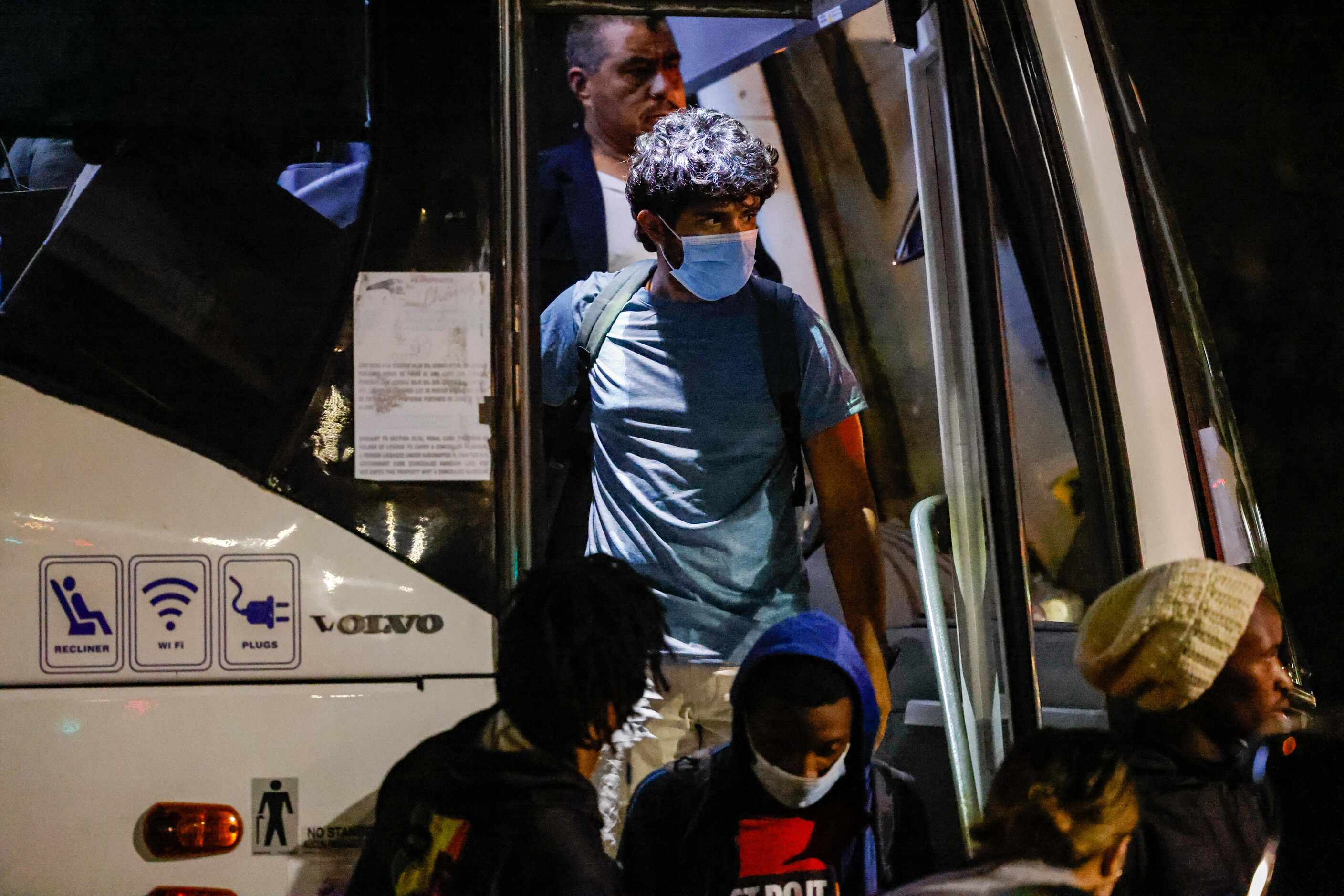 Victor Rodriguez, 26, disembarks the bus that took him along with a group of migrants from...