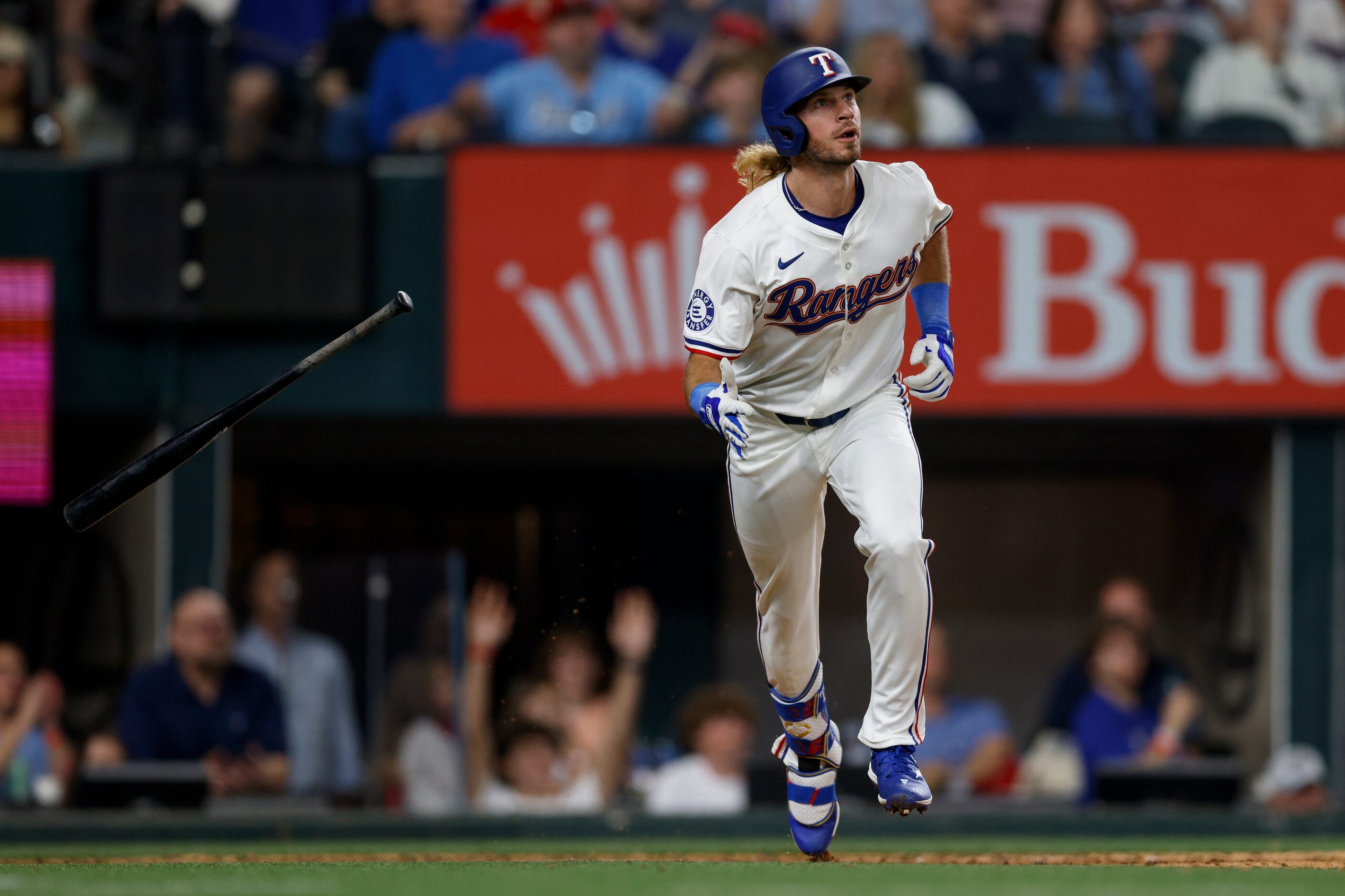 Texas Rangers left fielder Travis Jankowski (16) tosses his bat after hitting a home run...