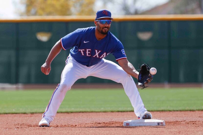 Texas Rangers infielder Marcus Semien makes a catch during a spring training workout at the...