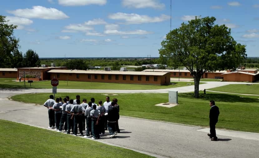 At the Gainesville State School, a group of male inmates prepared to march back to their...