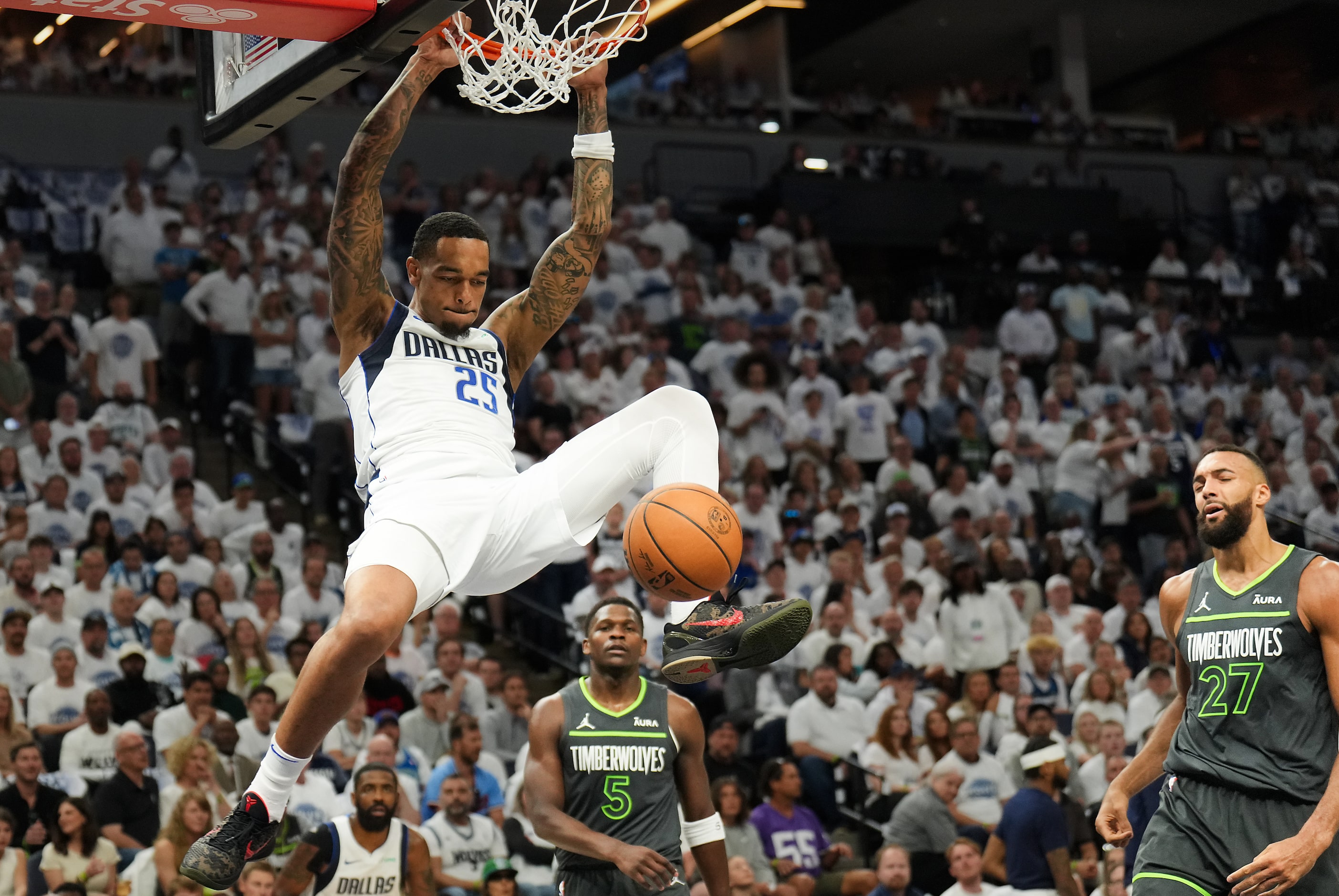 Dallas Mavericks forward P.J. Washington (25) dunks past Minnesota Timberwolves guard...