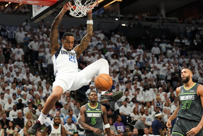 Dallas Mavericks forward P.J. Washington (25) dunks past Minnesota Timberwolves guard...