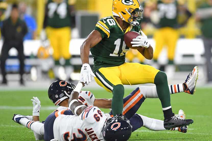 GREEN BAY, WI - SEPTEMBER 09:  Randall Cobb #18 is tackled by Bryce Callahan #37 of the...