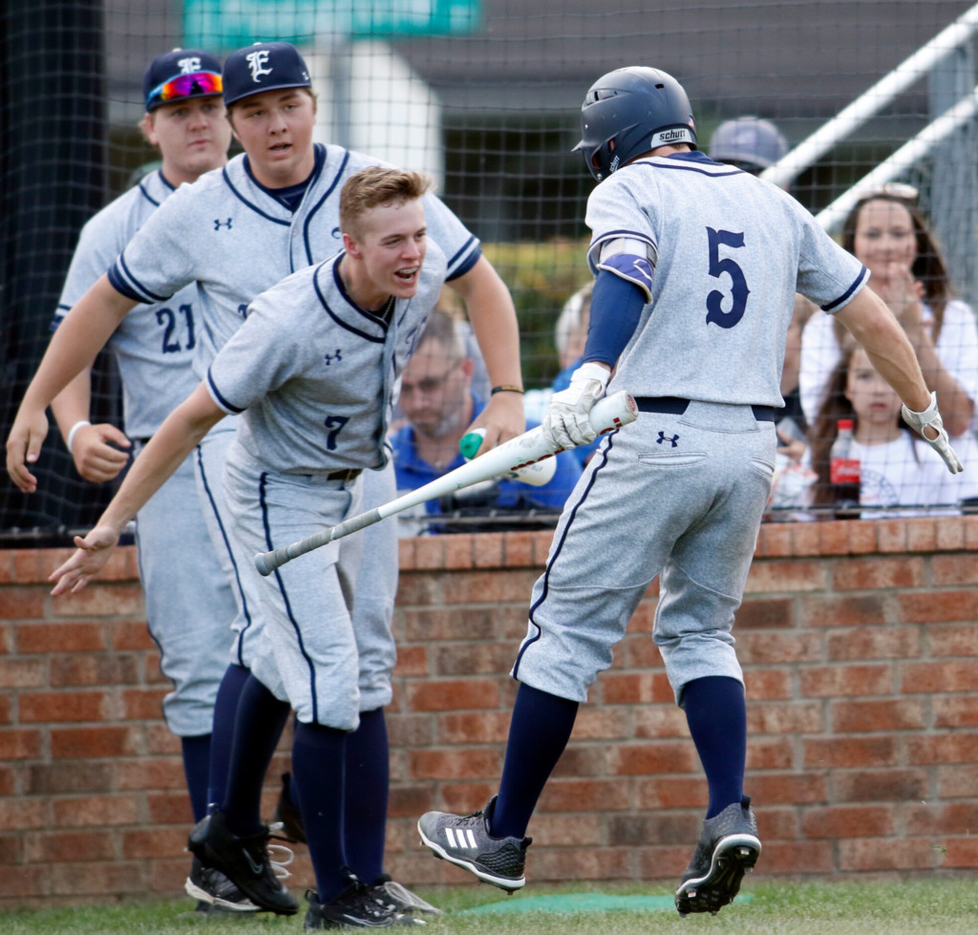 Northwest Eaton's Sean Klein (5) is greeted by teammate Zane Burnett (7) as he returned to...