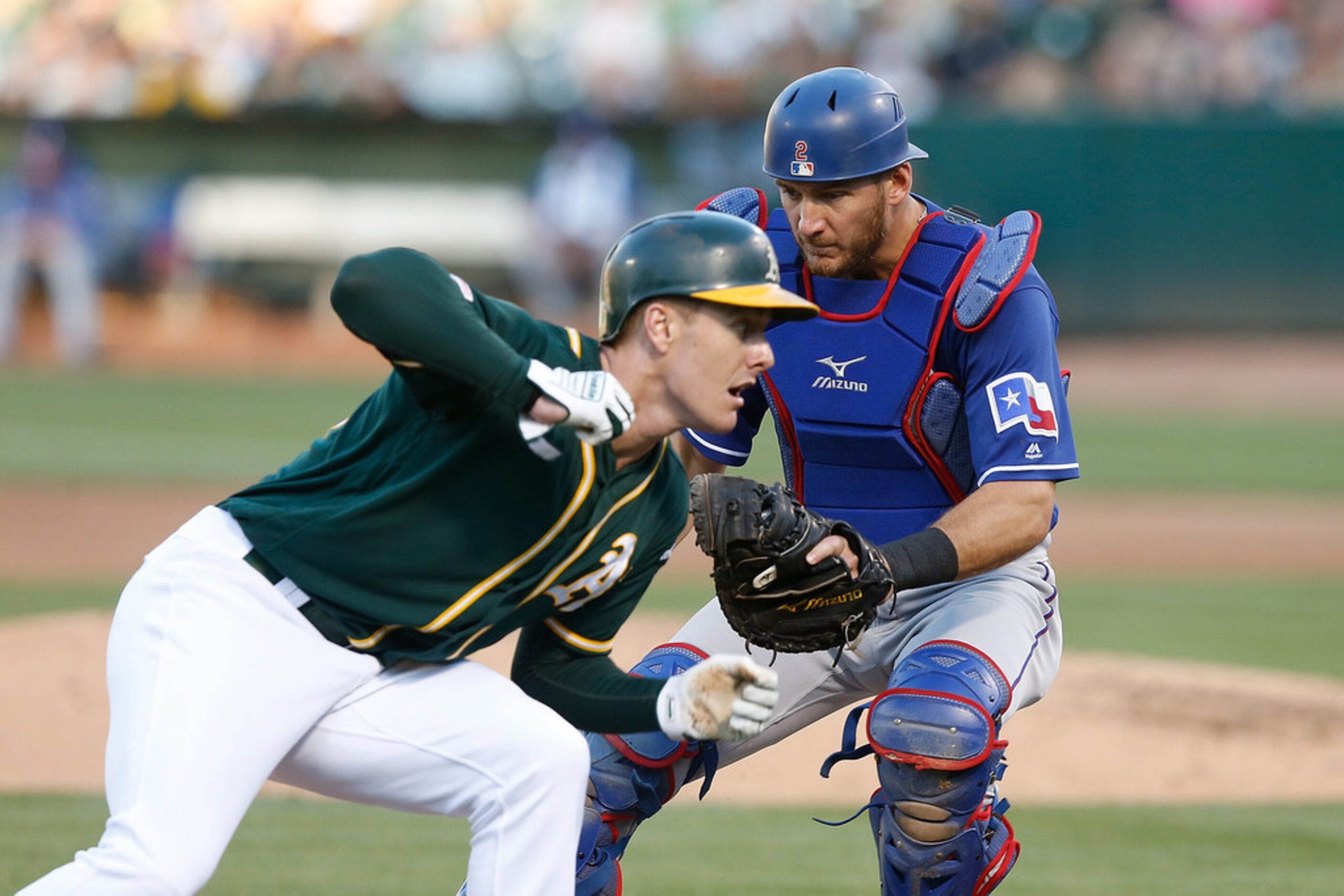 OAKLAND, CALIFORNIA - JULY 27: Catcher Jeff Mathis #2 of the Texas Rangers tags out base...