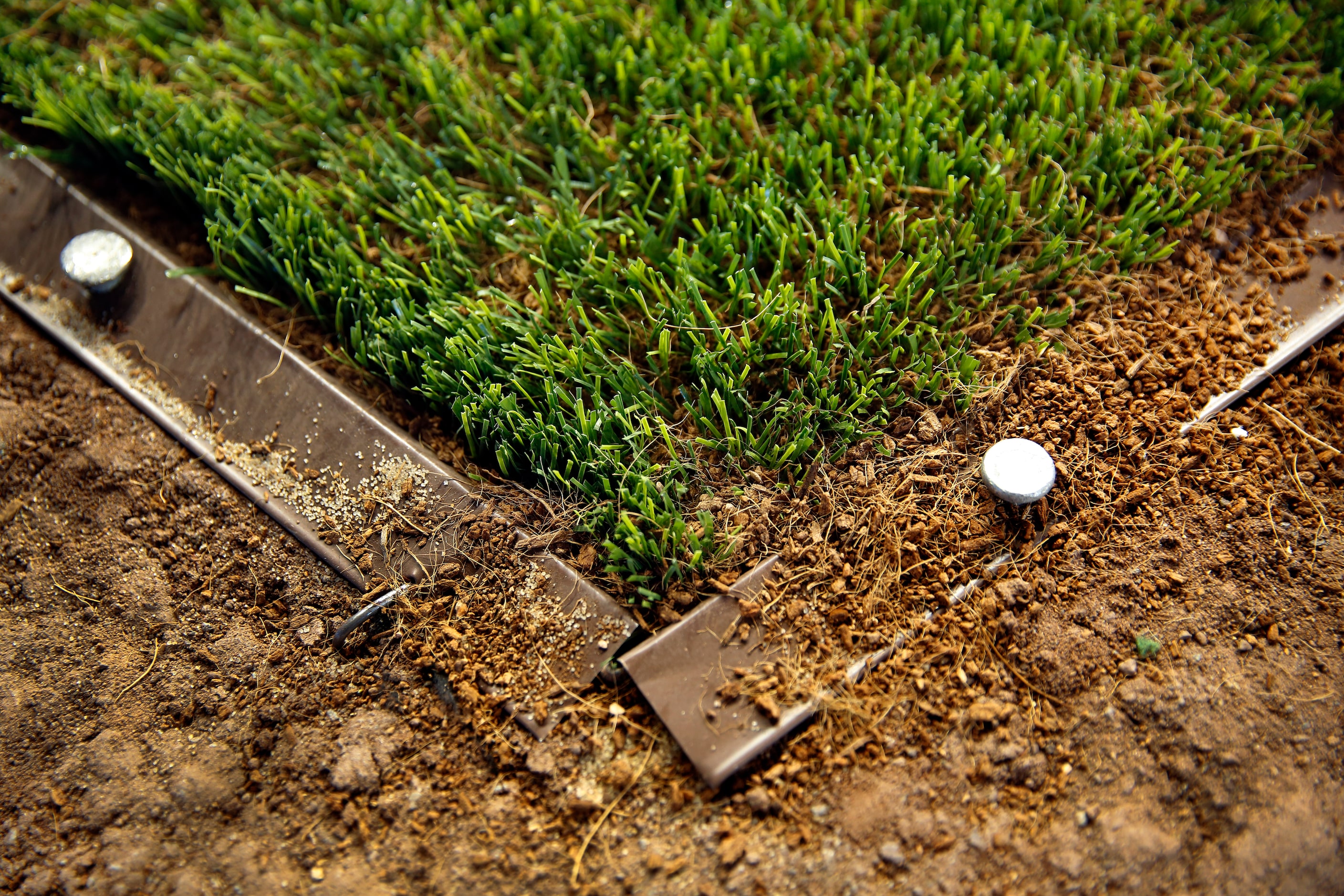 Shaw Sports Turf artificial turf with ground up coconut shell filler is being installed at...