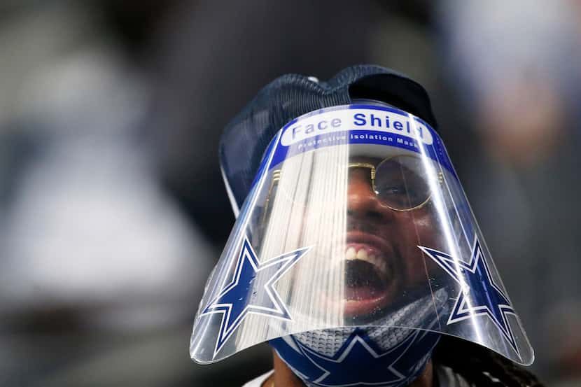 A Dallas Cowboys fan cheers for his team as they play the Atlanta Falcons at AT&T Stadium in...