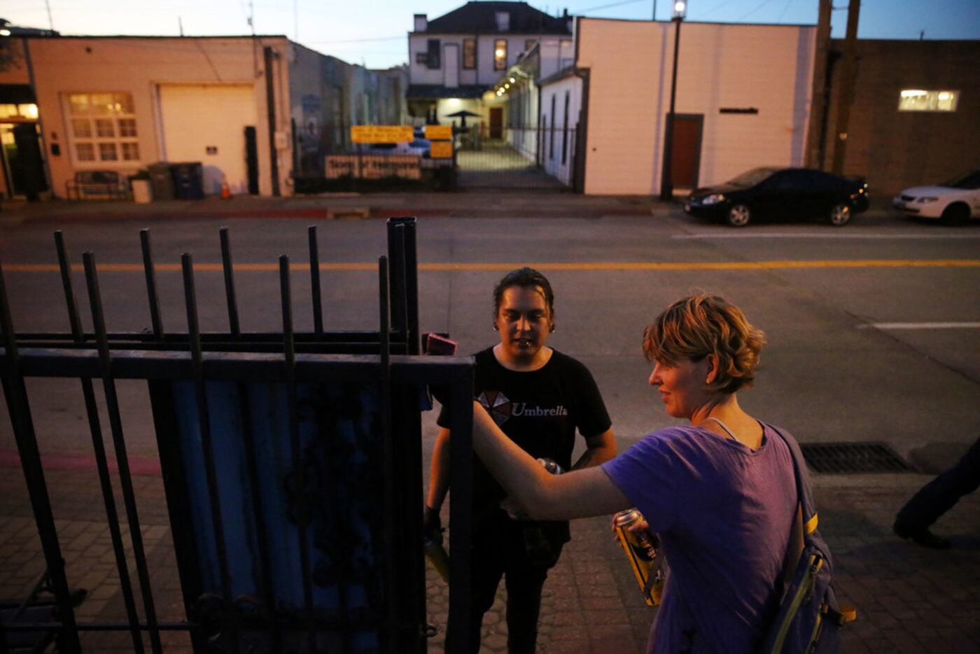 Angel Pacheco (center) and Adrienne Lichliter attempt to clean up a gate as community...