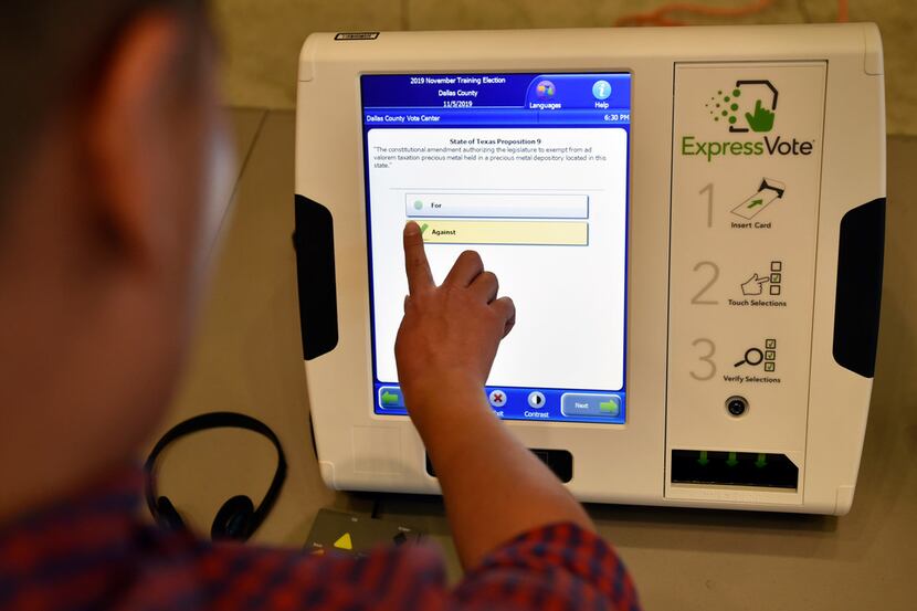Omar Jimenez, 27, of Dallas, uses the new ExpressVote election machine during a...