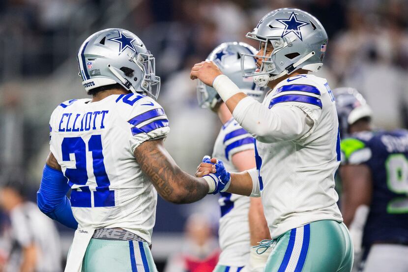 Cowboys running back Ezekiel Elliott (21) and quarterback Dak Prescott (4) celebrate a...