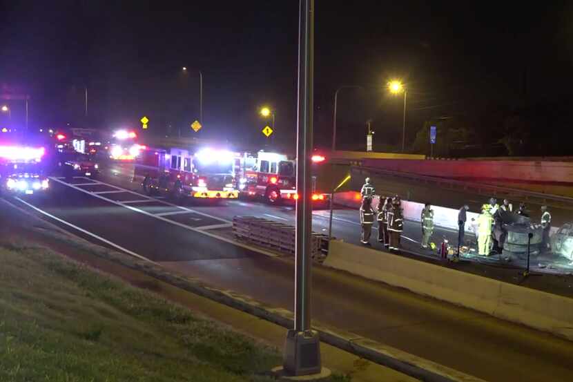 Law enforcement and fire officials at the scene of a crash that killed three people early...