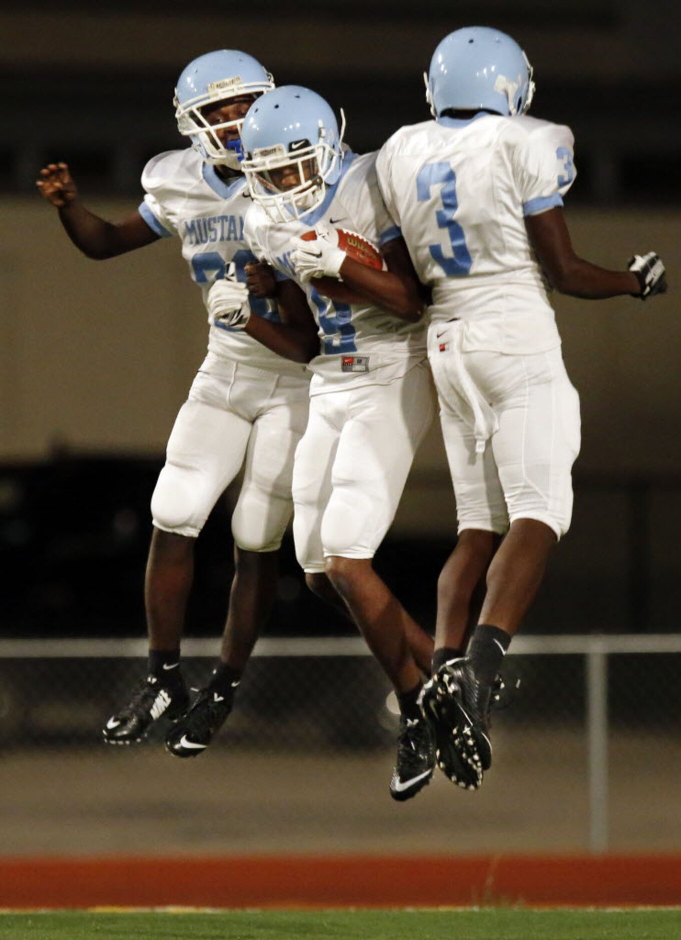 (TXHSFB) Roosevelt High's Vernon Vaughn (28); Donovan Davidson (9) and Damion Johnson (3)...