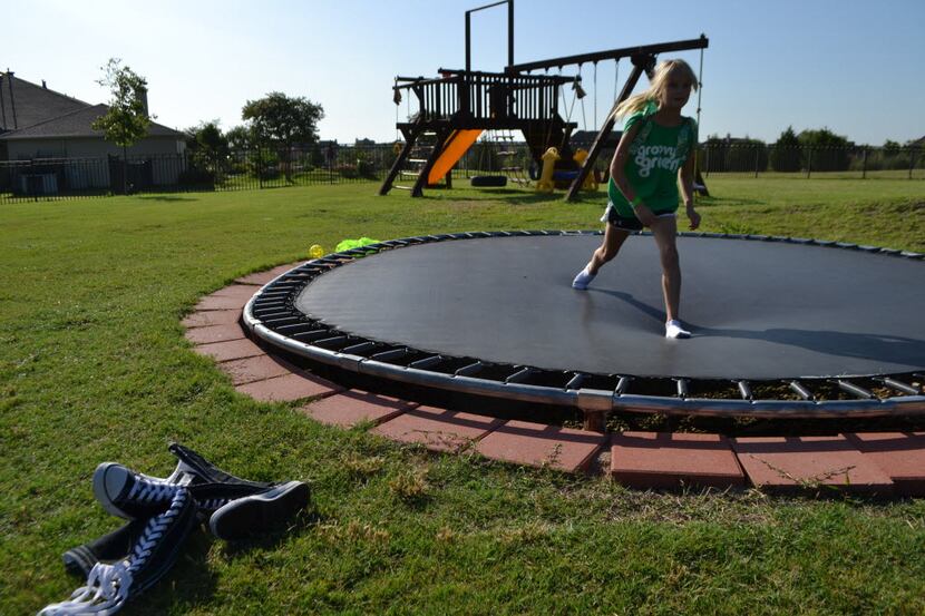 Sydney Hail plays on the trampoline in the backyard of her familyÃ¢â¬â¢s home in the...