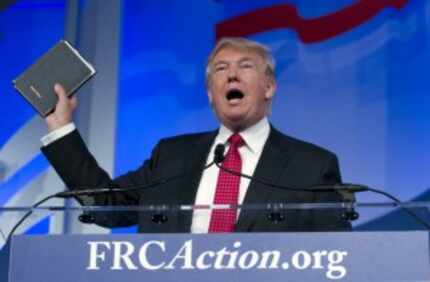  Donald Trump holds up a bible his mother gave him as a child, as he speaks at the Values...