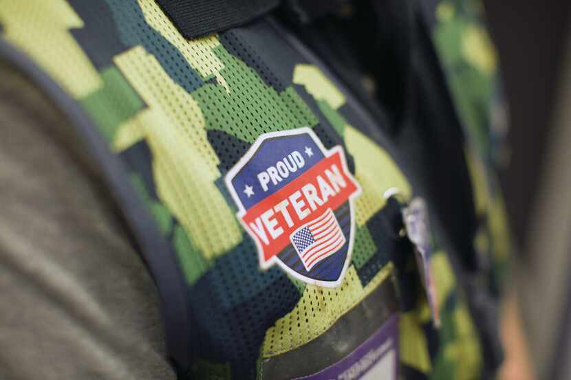 A close-up of a "Proud Veteran" tag that features an American flag on a Lowe's camouflage...