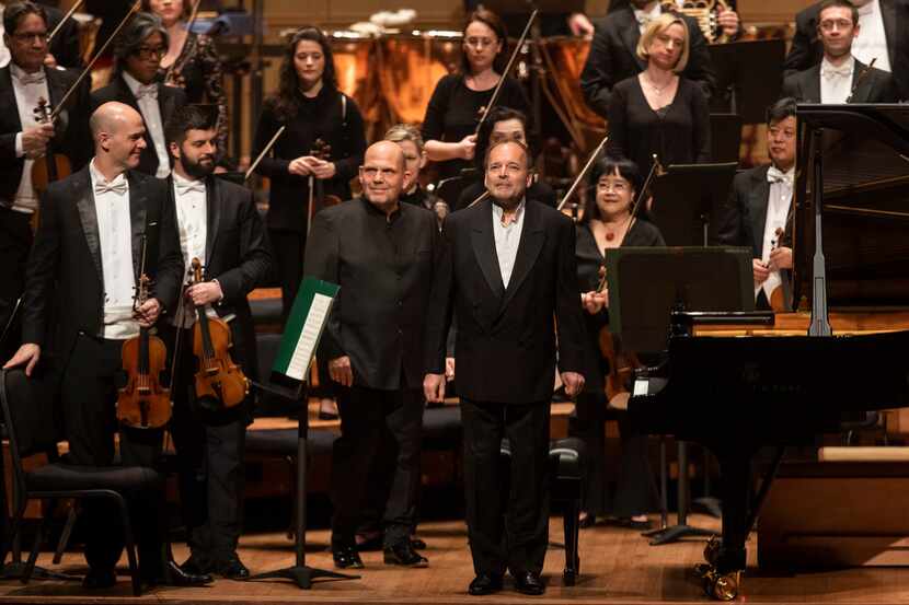 Dallas Symphony Orchestra conductor laureate Jaap van Zweden (center) takes the stage with...