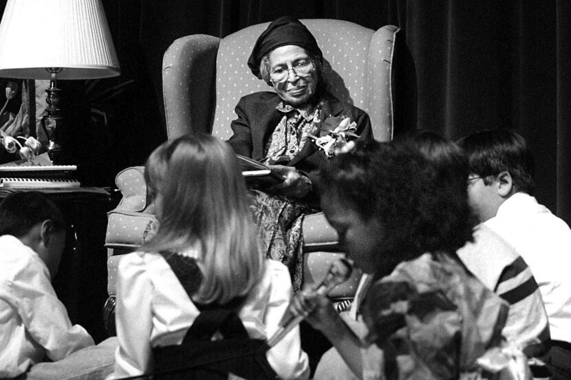 2/15/95--Civil rights leader Rosa Parks listens to second-grader Samantha Clark read a poem...