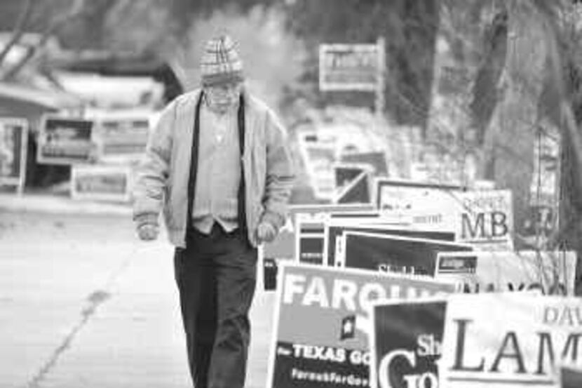  John Dunnigan of Oak Cliff checked out the campaign signs as he walked past the Dallas...