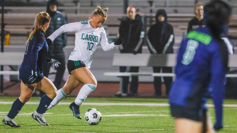 Southlake Carroll High School sophomore midfielder Kennedy Fuller (10) dribbles the ball...