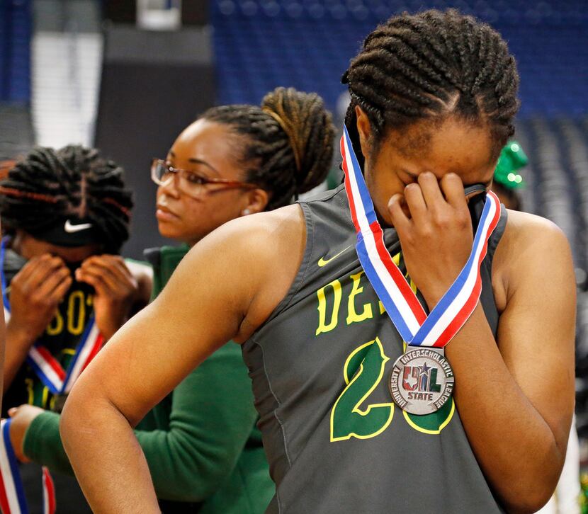 Desoto's Ash'a Thompson can't hide her disappointment as other members console each other....