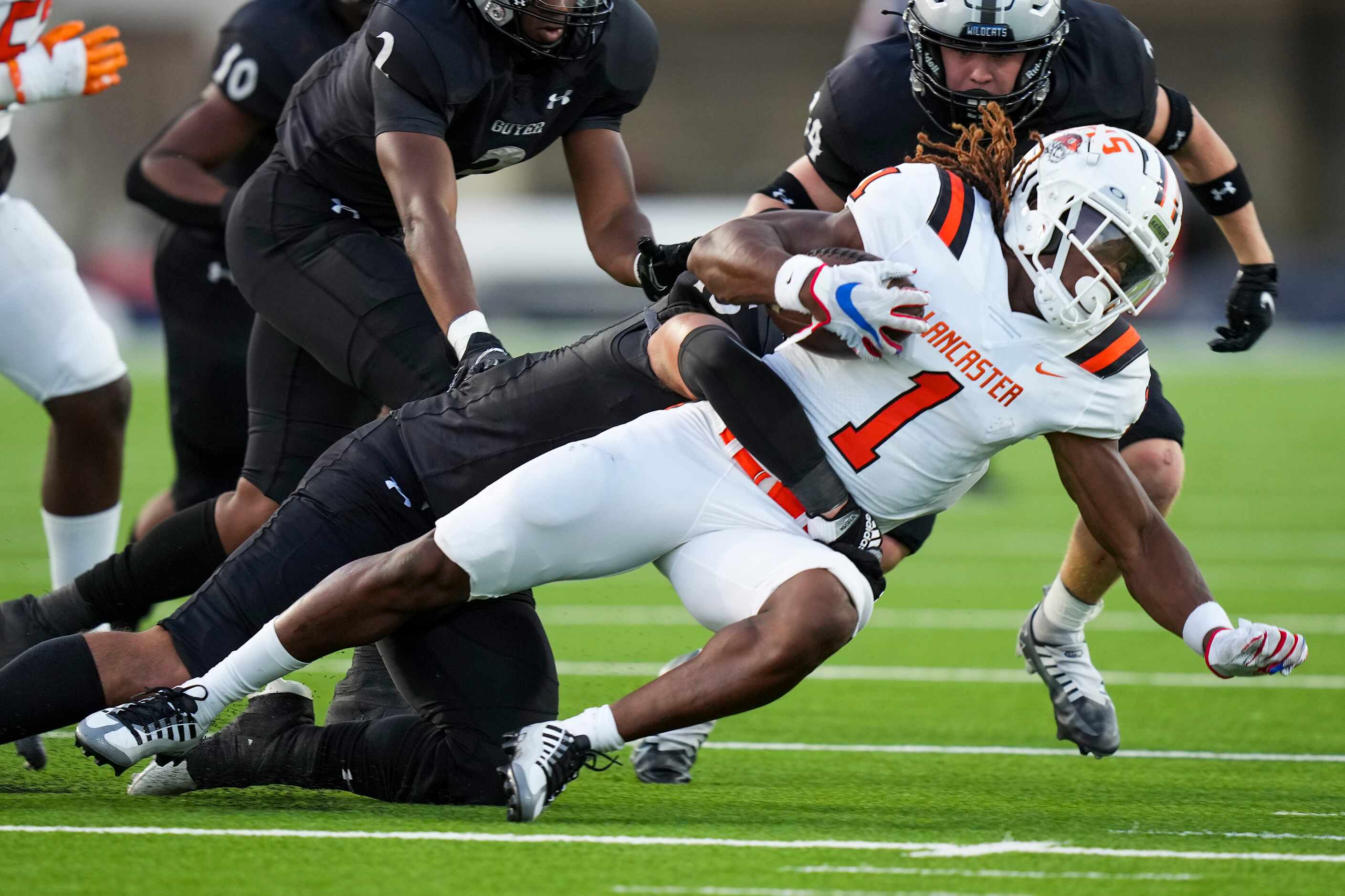 Lancaster running back Kyson Brown (1) is brought down by the Denton Guyer defense during...