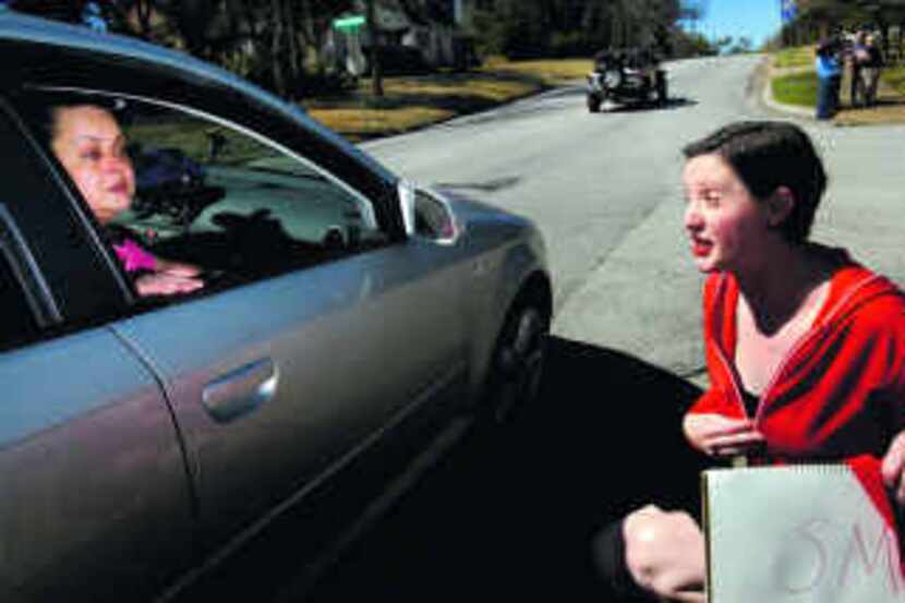  Kim Ikovic (in car) talked to Ashley Head, who was part of a small protest Tuesday in Oak...