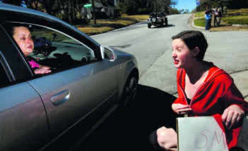  Kim Ikovic (in car) talked to Ashley Head, who was part of a small protest Tuesday in Oak...