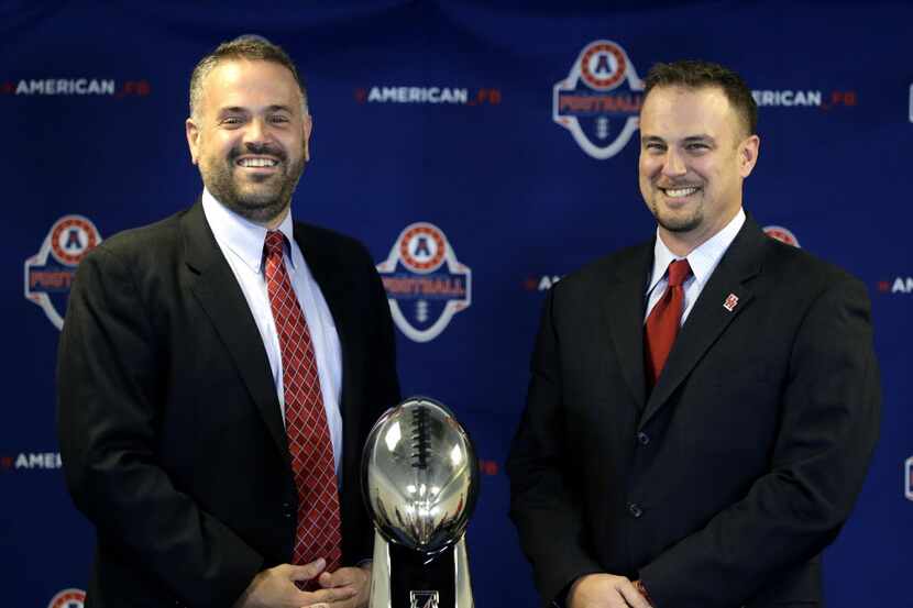 Temple coach Matt Rhule, left, and Houston coach Tom Herman pose with the trophy during an...