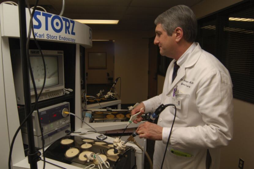 Dr. Edward Livingston demonstrates simulation training equipment at UT Southwestern’s Center...