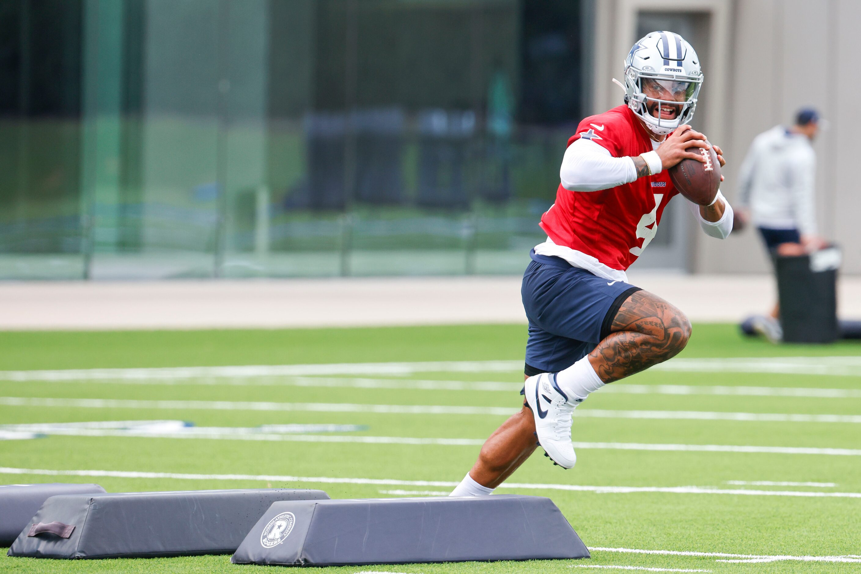 Dallas Cowboys quarterback Dak Prescott (4) runs a drill as he looks to throw the ball...