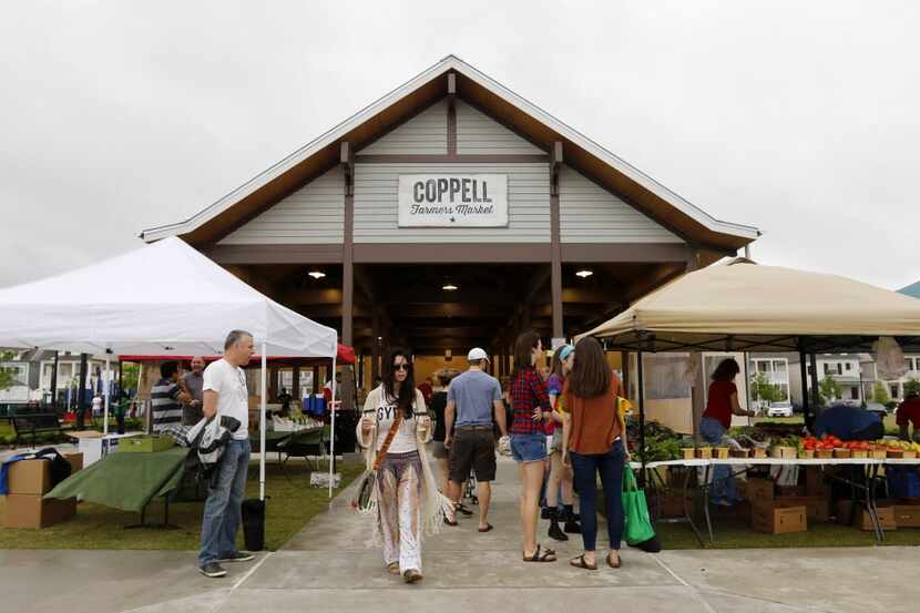 People shop for goods at the Coppell Farmers Market in Coppell, Texas on May 9, 2015. (Rose...