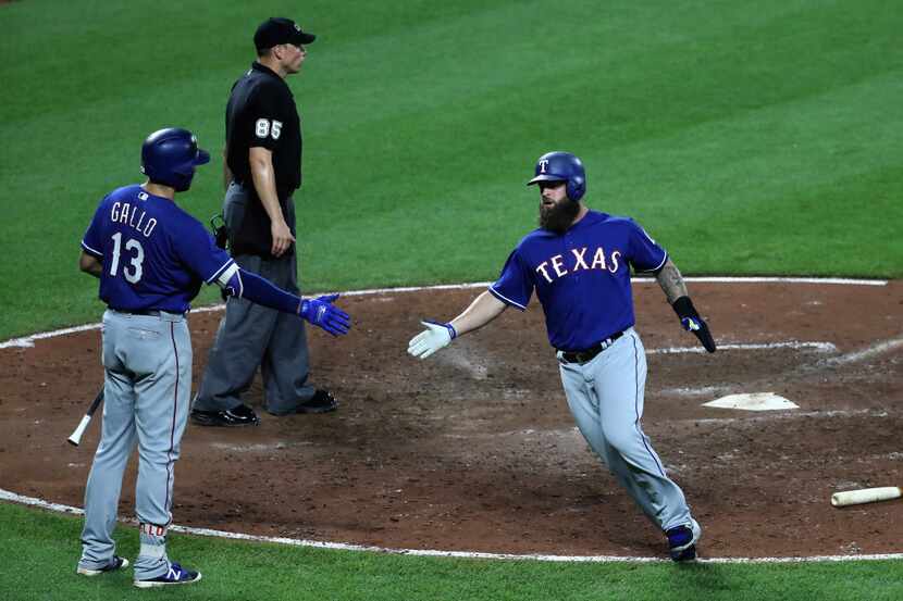 BALTIMORE, MD - JULY 19: Mike Napoli #5 of the Texas Rangers celebrates with Joey Gallo #13...