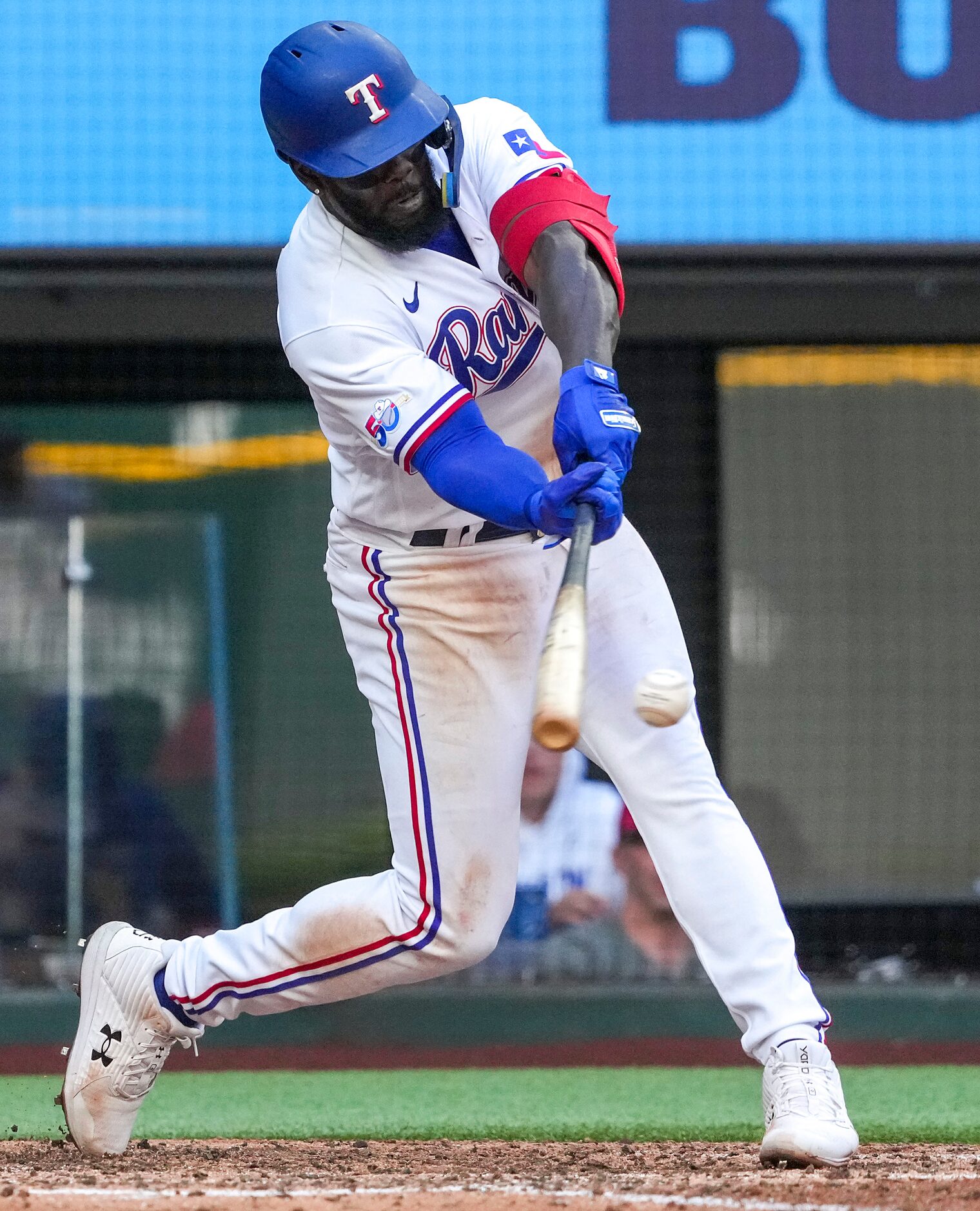 Texas Rangers center fielder Adolis Garcia drives in two runs with a single during the fifth...