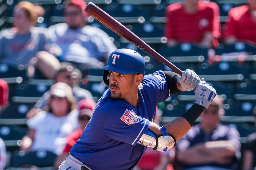 Texas Rangers first baseman Ronald Guzman bats during the second inning of a spring training...