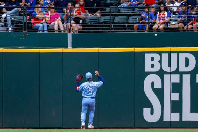 Texas Rangers left fielder Willie Calhoun (5) reacts to a ground rule double by Cleveland...