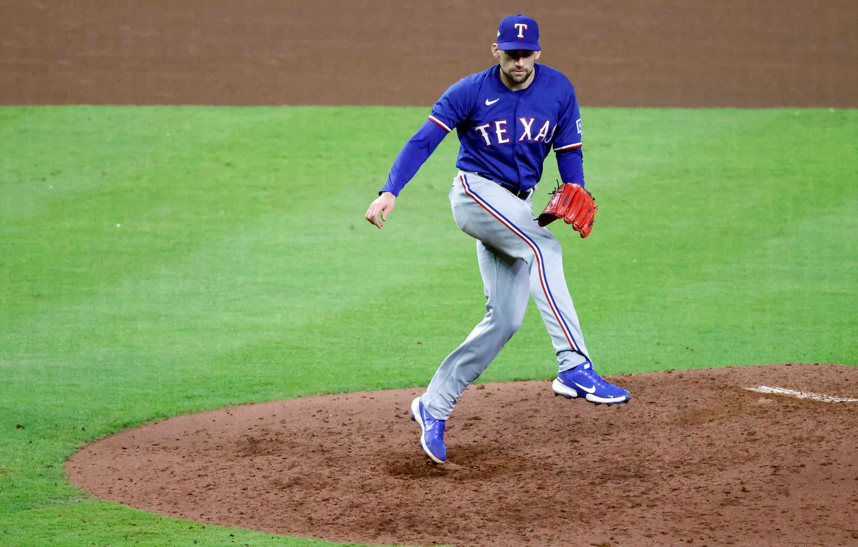 Texas Rangers starting pitcher Nathan Eovaldi (17) follows through on a seventh inning pitch...