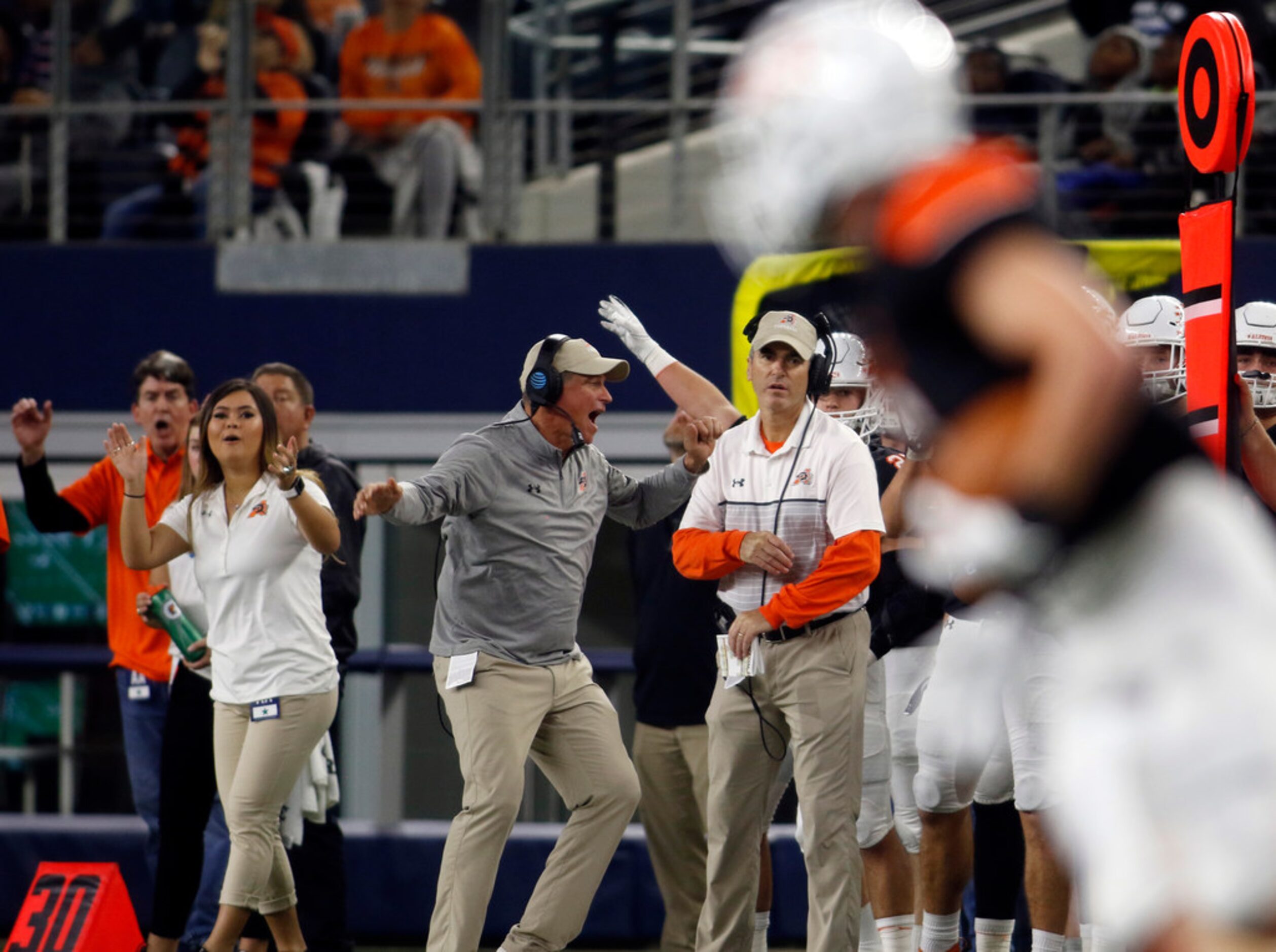 The Aledo bench reacts after Bearcats safety Nathan Fingar (3) returns an interception...