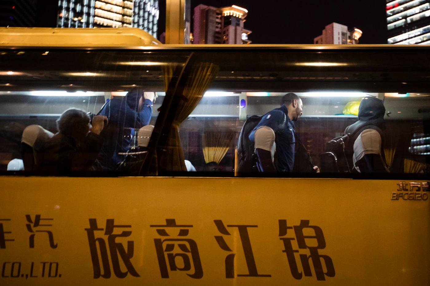 Dallas Mavericks players, including guard Devin Harris (center) exit the team buses as they...