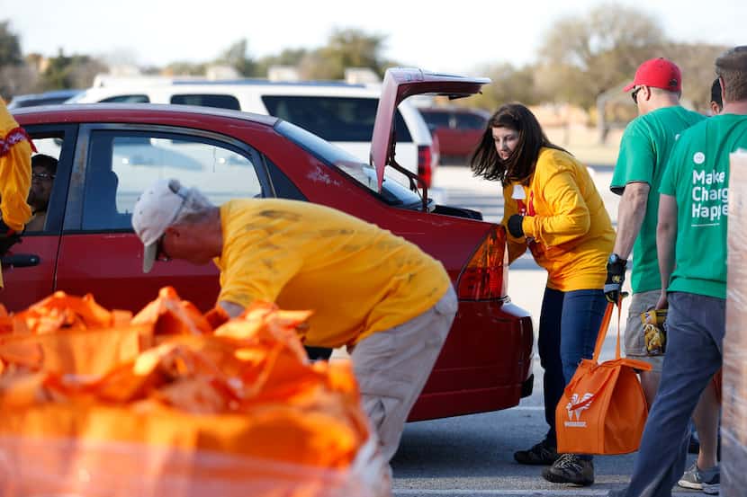 Helpers for The Storehouse of Collin County distribute 1,350 Thanksgiving meals to those in...