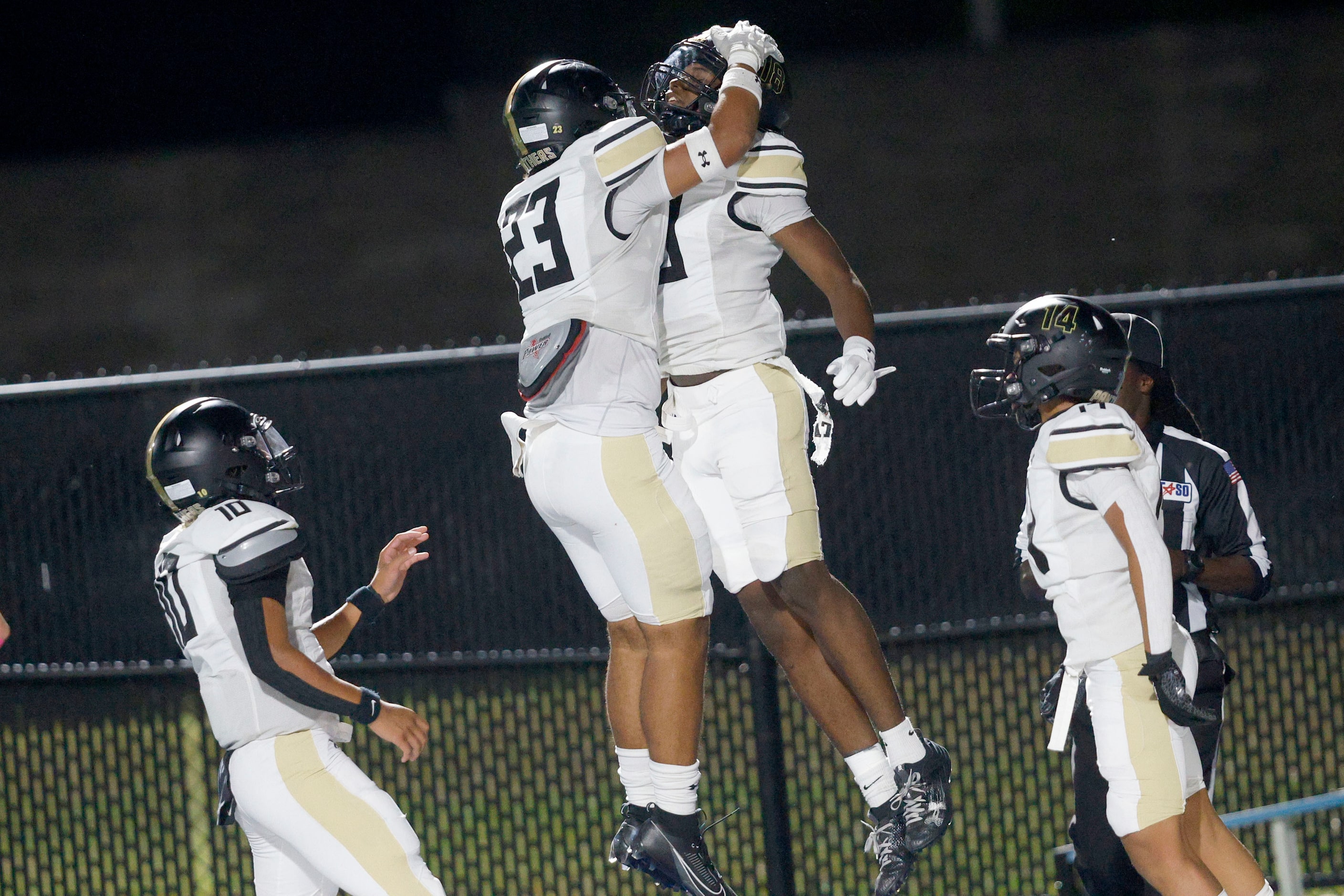 Fossil Ridge's Jayden Cowan (18), second from right, celebrates with his teammates Brayden...